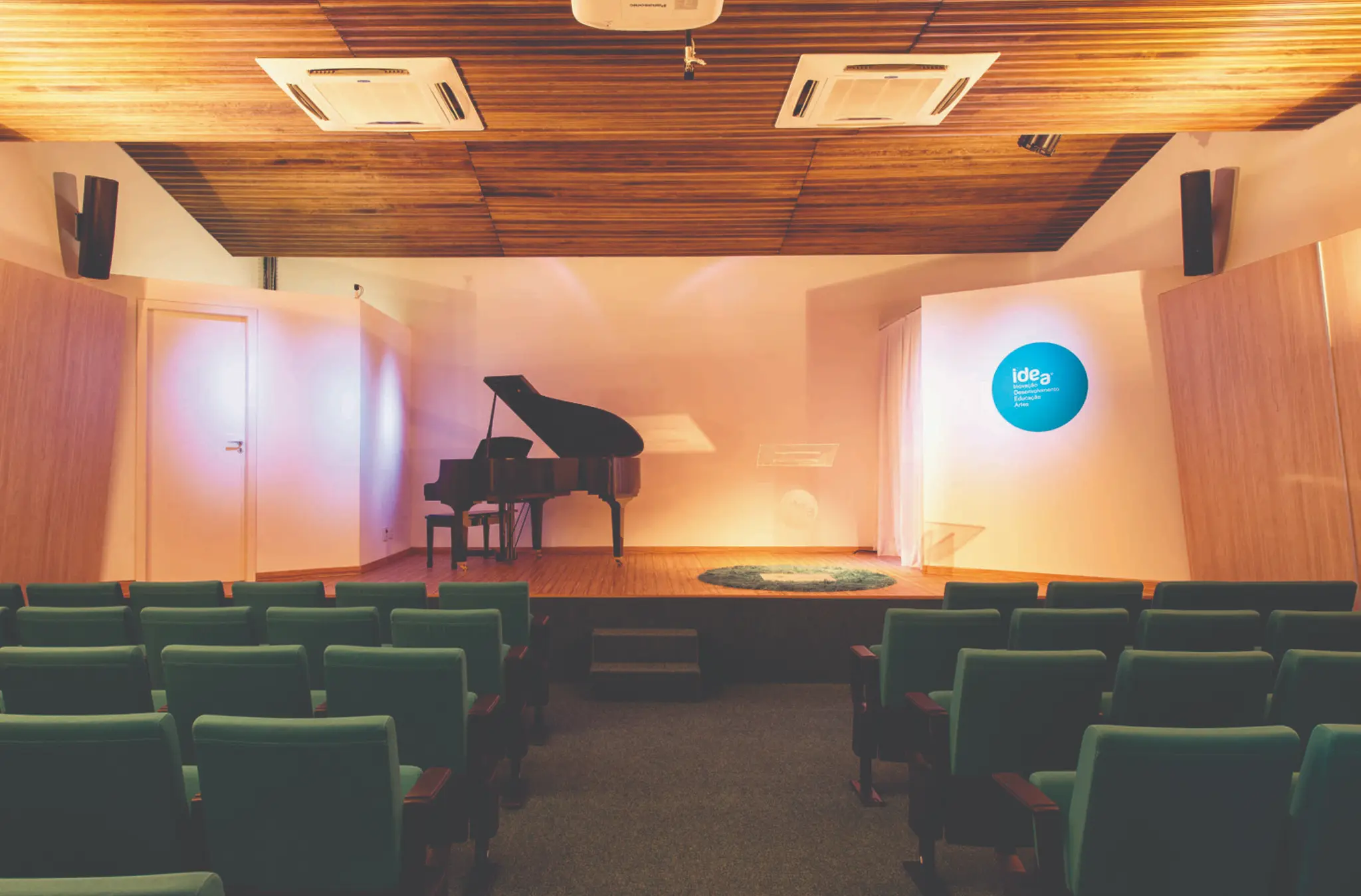 Sala principal do Centro Cultural IDEA vazia, com palco e assentos.